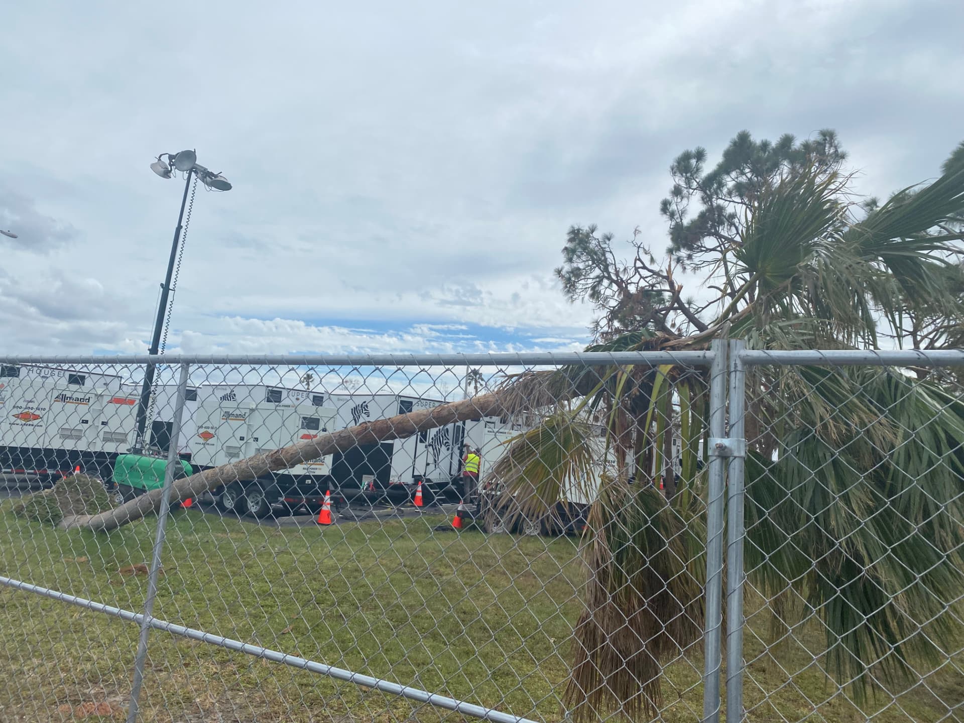 Light towers staged behind fence